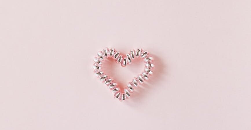 decorative heart of elastic coil on pink background